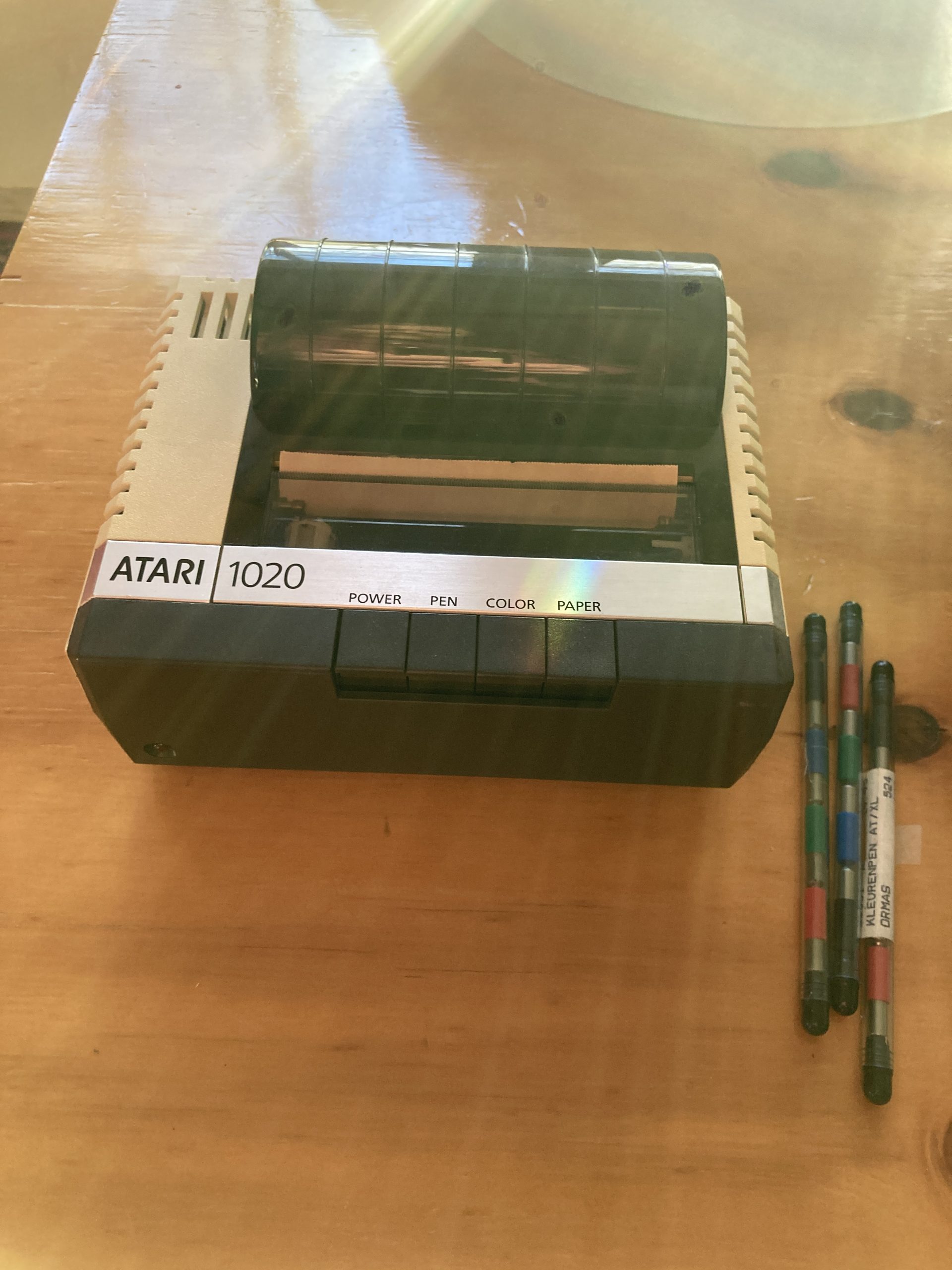 Atari 1020 plotter on table with a few pens